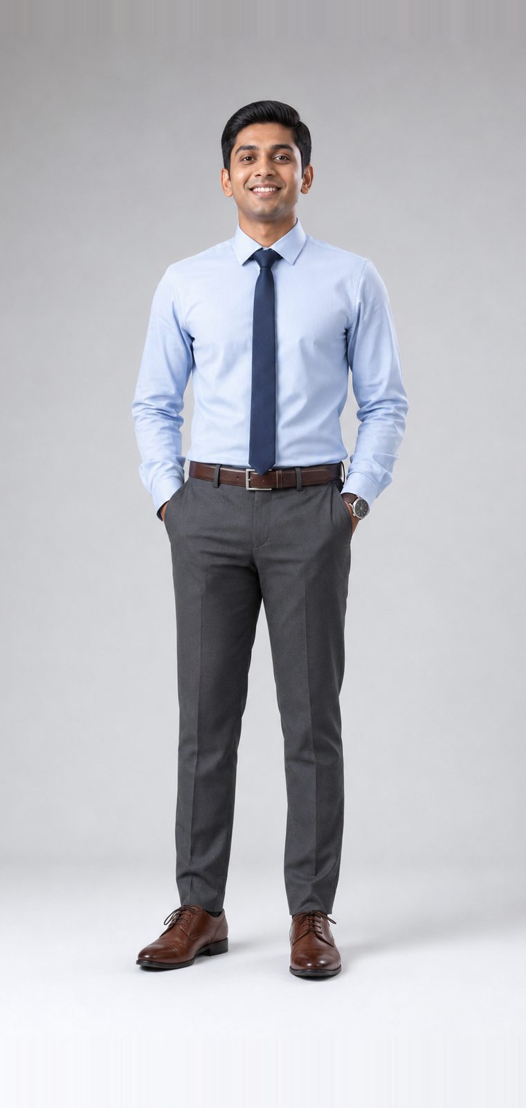 Man in a light blue dress shirt, navy knitted tie, charcoal tailored trousers and brown laced shoes: Business level attire