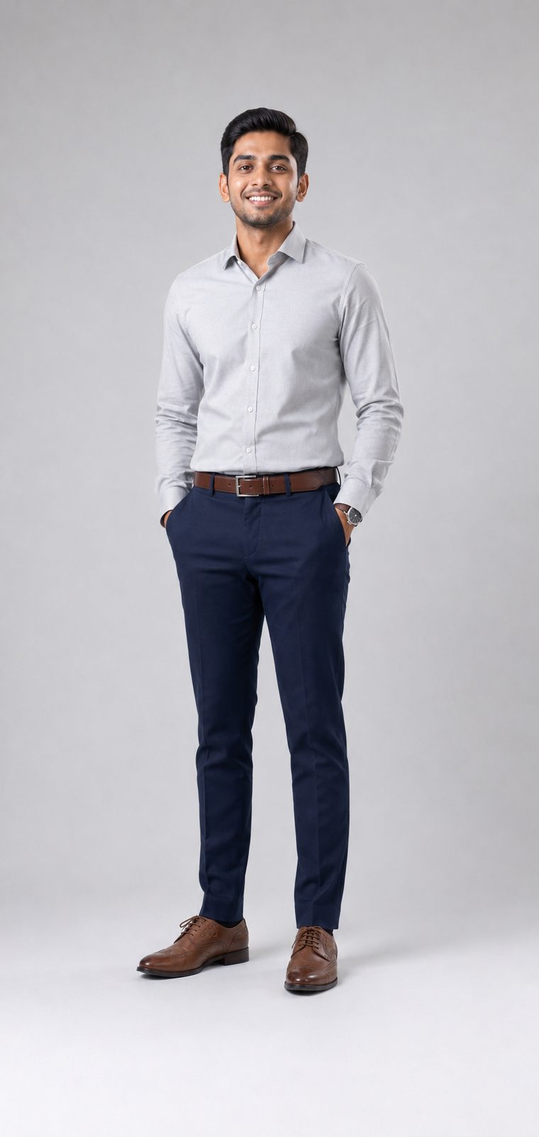 Man in a light grey dress shirt, navy tailored trousers, brown belt and brown brogues: Business Casual attire