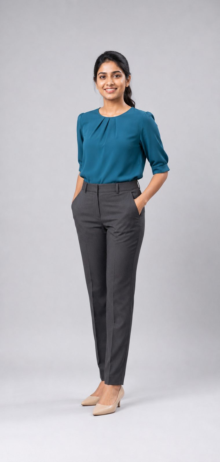 Woman in a teal pleated-neck blouse, charcoal tailored trousers and nude pointed heels: Business Casual attire