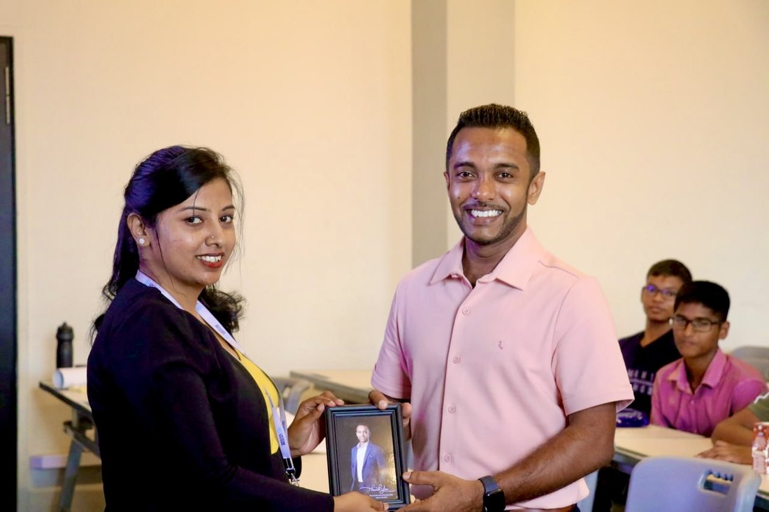 Receiving a token of appreciation from Lyceum International School