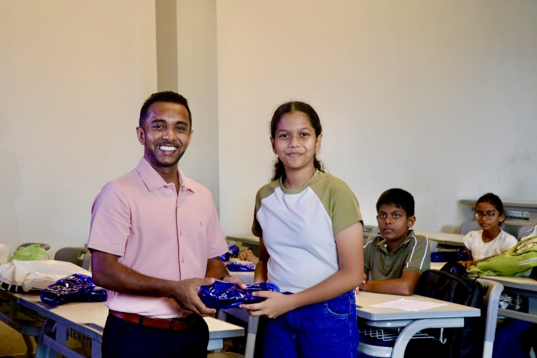 A student receiving her workbook during the Lyceum leadership programme